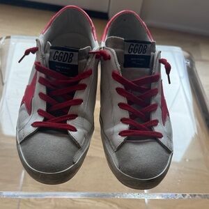 Golden Goose Superstar Sneakers. White with pink star and red laces.